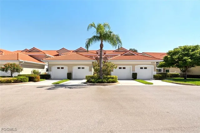 a view of swimming pool with outdoor seating and trees in the background