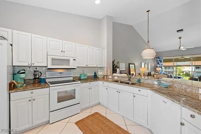 a dining room with furniture and a floor to ceiling window