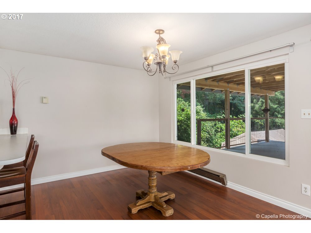 21001 Northwest St Helens Road Portland, OR 97231 - Photo 8 of 30 a view of a dining room with furniture a chandelier and wooden floor