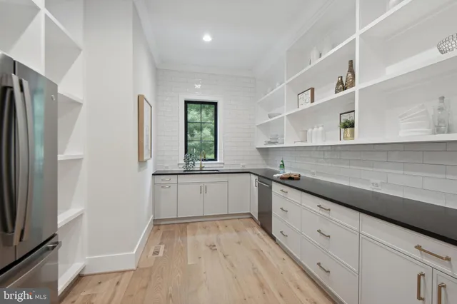 a living room with furniture white walls and a view of kitchen