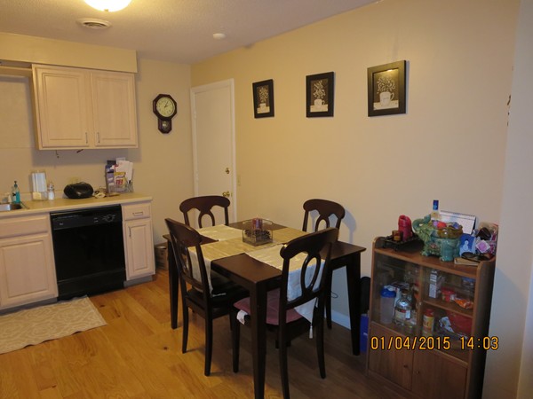 92 Beacon Street, Unit 5 Lawrence, MA 01843 - Photo 2 of 15 a view of a dining room with furniture and wooden floor