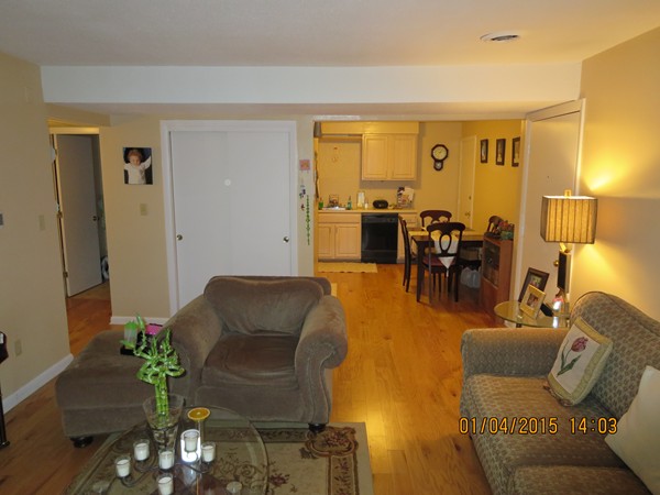92 Beacon Street, Unit 5 Lawrence, MA 01843 - Photo 5 of 15 a living room with furniture dining table and a lamp