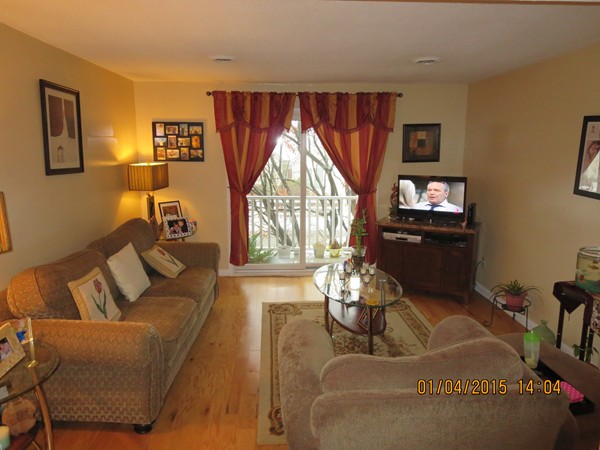 92 Beacon Street, Unit 5 Lawrence, MA 01843 - Photo 6 of 15 a living room with furniture and a large window