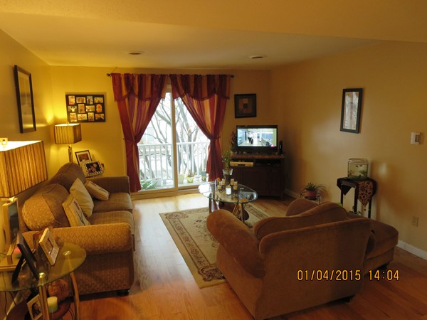 92 Beacon Street, Unit 5 Lawrence, MA 01843 - Photo 7 of 15 a living room with furniture and a large window