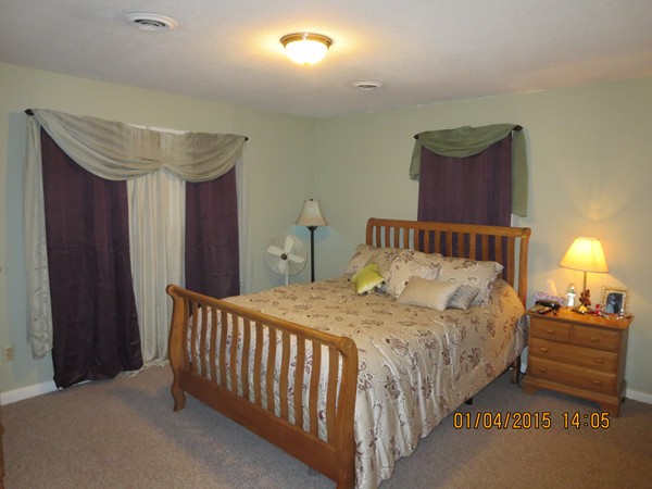 92 Beacon Street, Unit 5 Lawrence, MA 01843 - Photo 9 of 15 a bedroom with a bed and a lamp