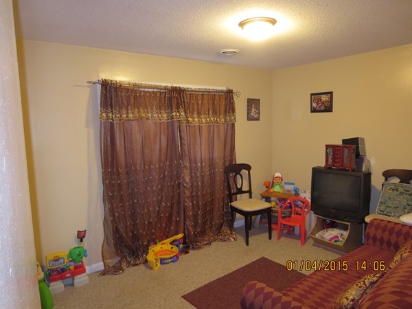 92 Beacon Street, Unit 5 Lawrence, MA 01843 - Photo 10 of 15 a bedroom with furniture and a gate