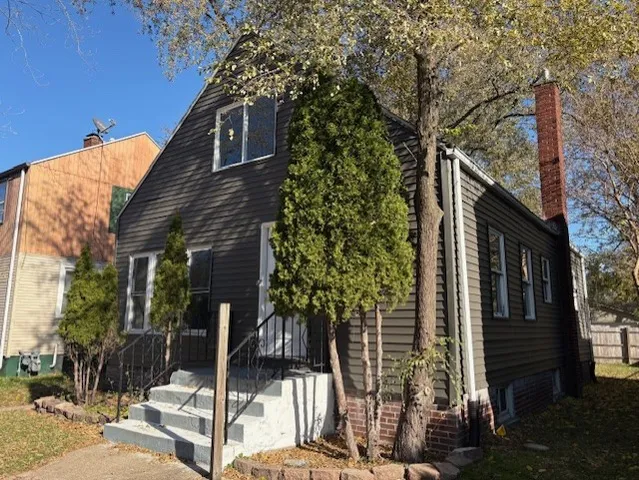 a front view of a house with trees