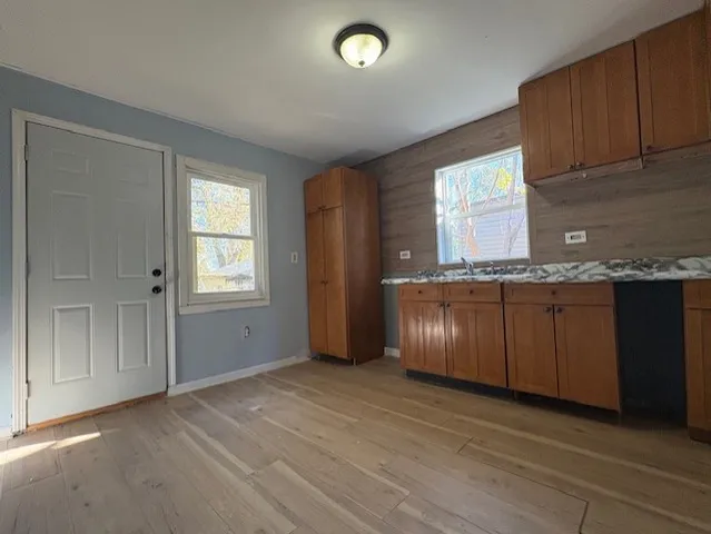a view of kitchen with granite countertop cabinets