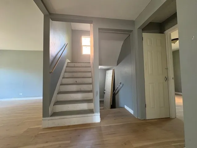 a view of entryway and hall with wooden floor