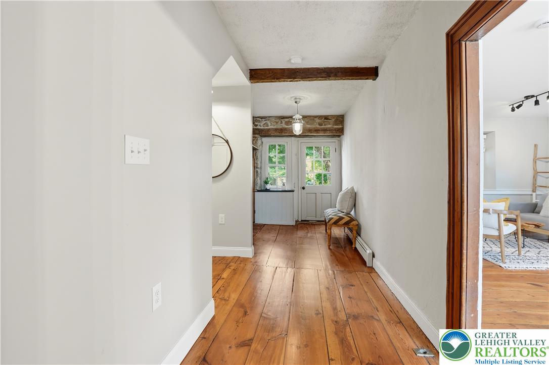 2014 Linden Street Bethlehem, PA 18017 - Photo 5 of 85 Hearty wood flooring extends throughout this inviting entryway, showcasing rustic ceiling beams and French doors.