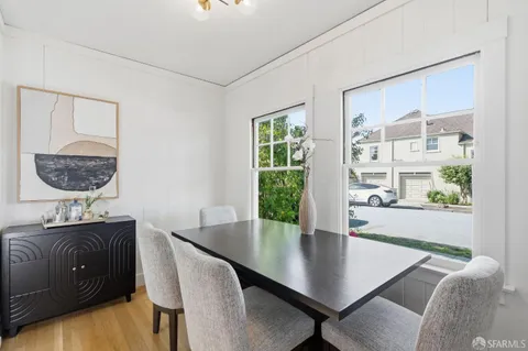 a view of a dining room with a table and chairs