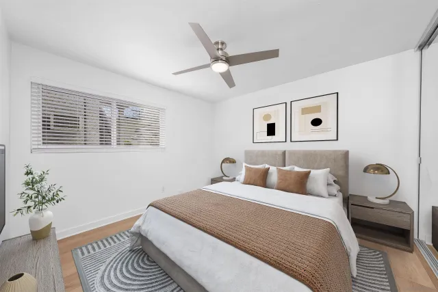 a bedroom with a large bed and a window