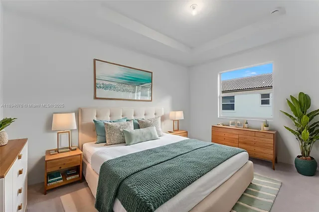 a bedroom with a bed and a potted plant