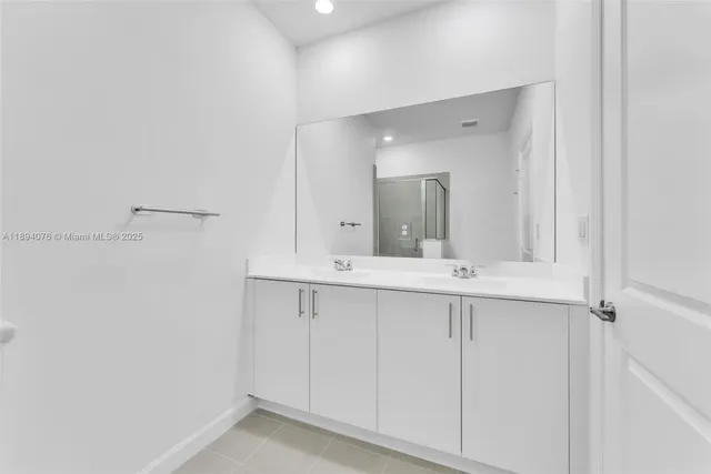 a bathroom with a double vanity sink and mirror