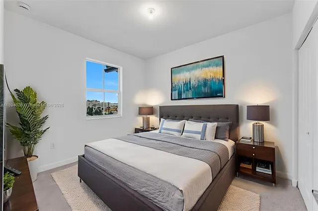 a bedroom with bed and a potted plant