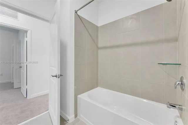 a bedroom with a large bed and a couch