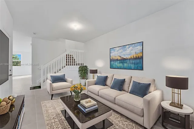 a living room with furniture a rug and a lamp