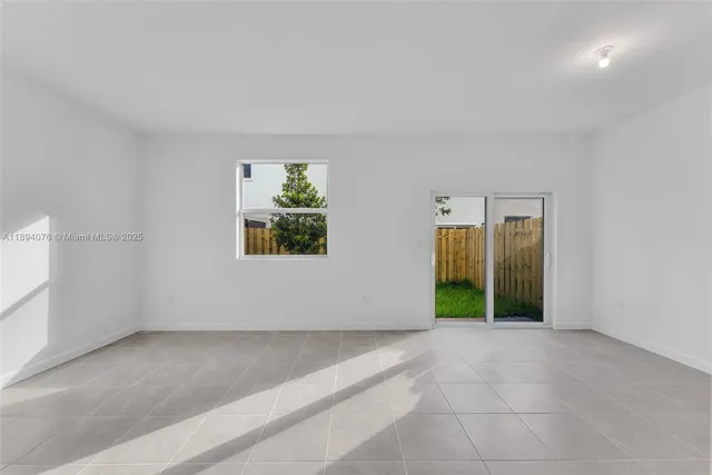 an empty room with windows and entrance