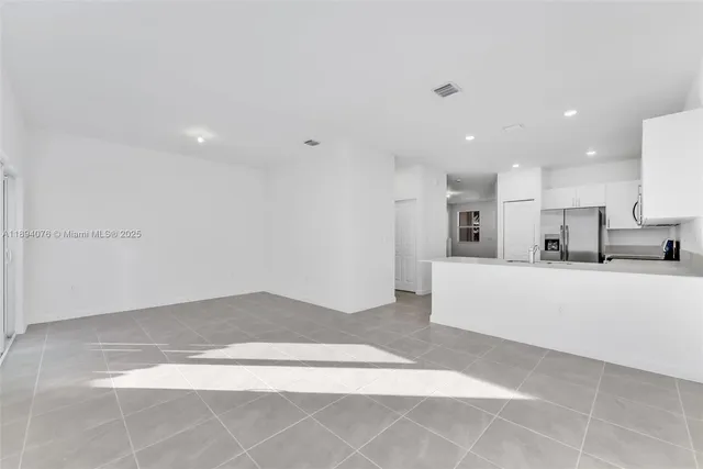 a view of kitchen with kitchen island and stainless steel appliances