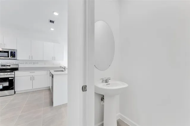 a bathroom with a sink a toilet and mirror