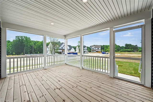 a view of a wooden deck with large trees
