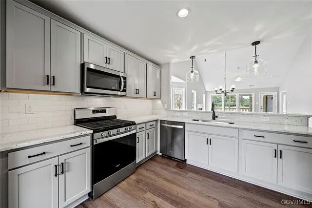 a kitchen with granite countertop white cabinets and appliances