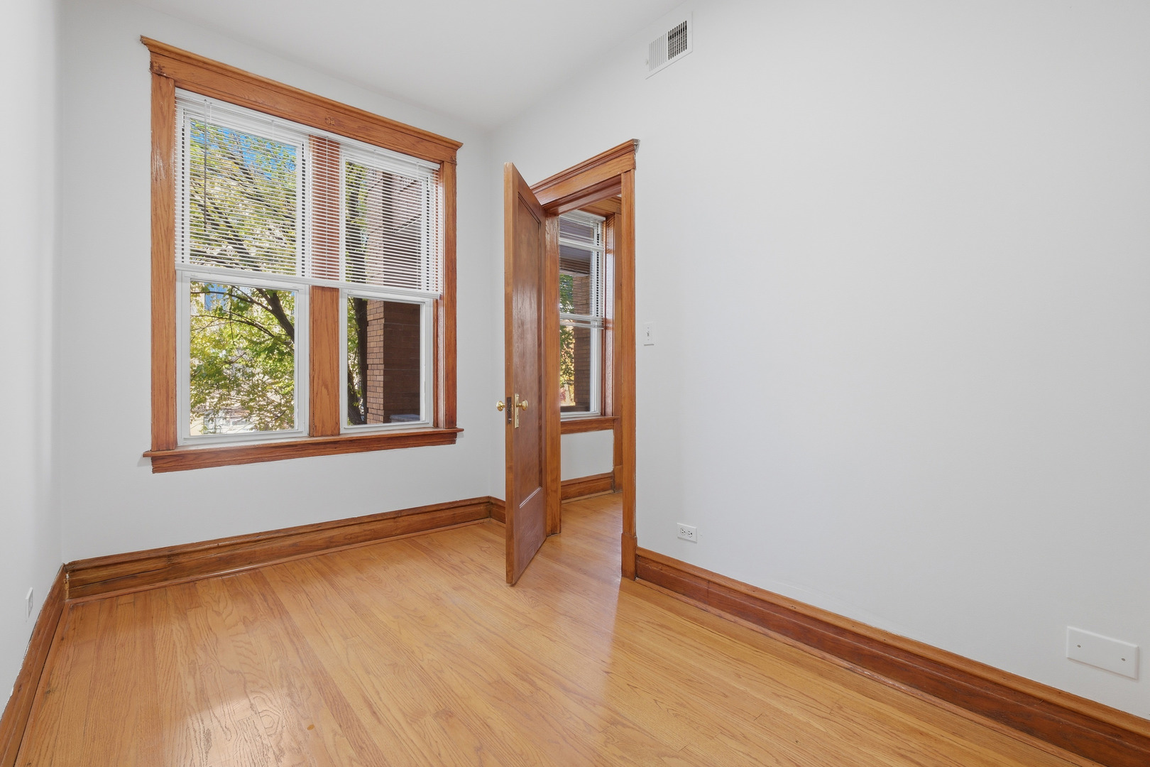 823 North Hoyne Avenue, Unit 2 Chicago, IL 60622 - Photo 8 of 20 an empty room with wooden floor and windows