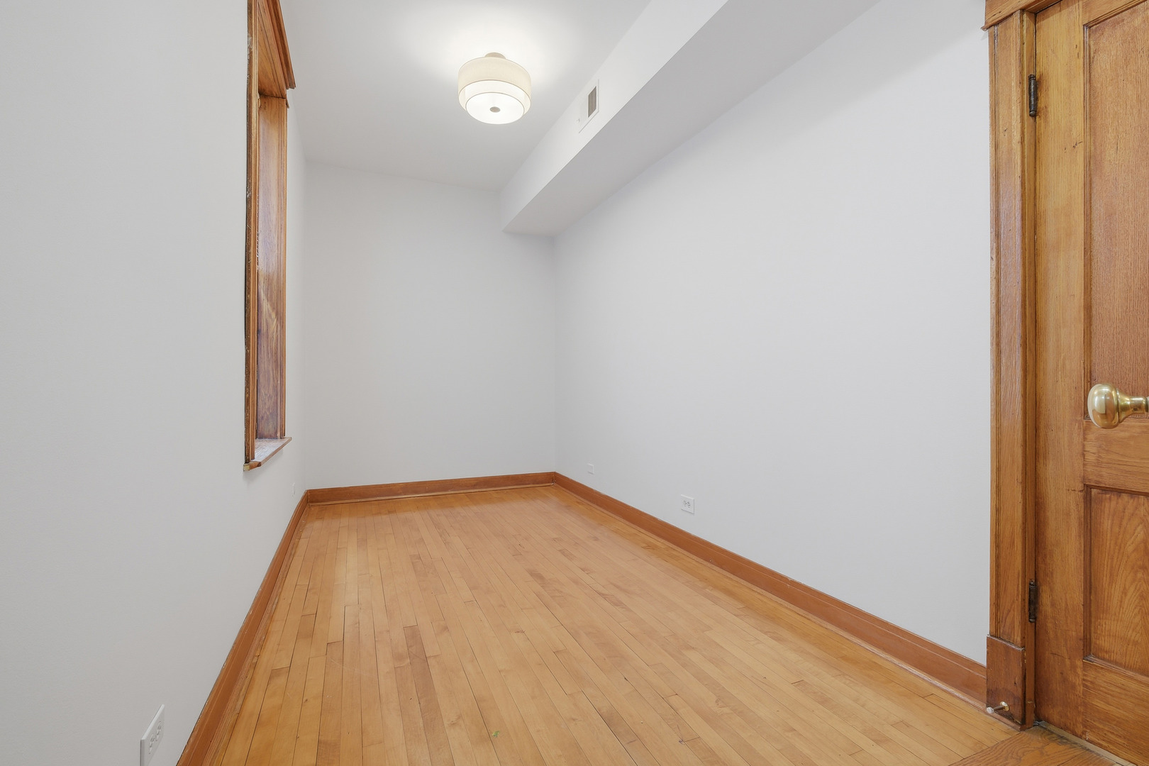 823 North Hoyne Avenue, Unit 2 Chicago, IL 60622 - Photo 9 of 20 a view of a room with wooden floor and brick wall
