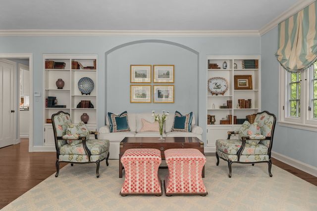 a living room with furniture fireplace and a table