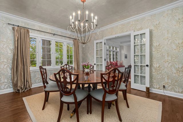 a view of dining table chairs and wooden floor