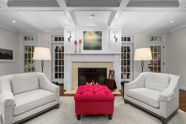 a living room with furniture and floor to ceiling window