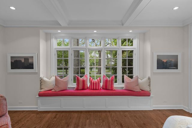 a living room with furniture a fireplace and a large window