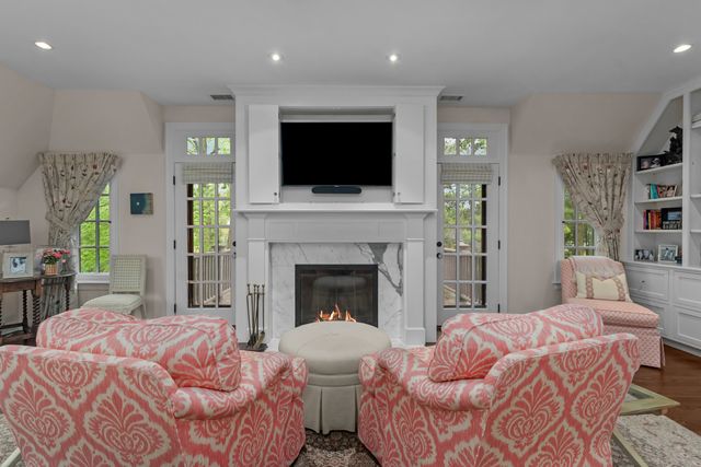 a bedroom with a large bed and a fireplace