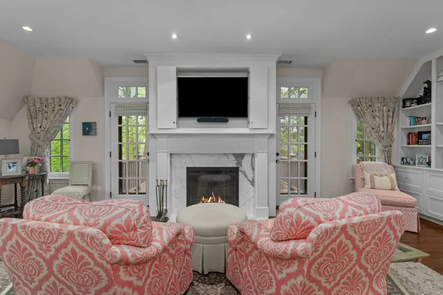 a bedroom with a large bed and a fireplace