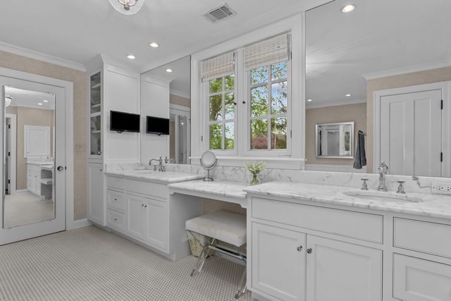a bathroom with a double vanity sink and a mirror