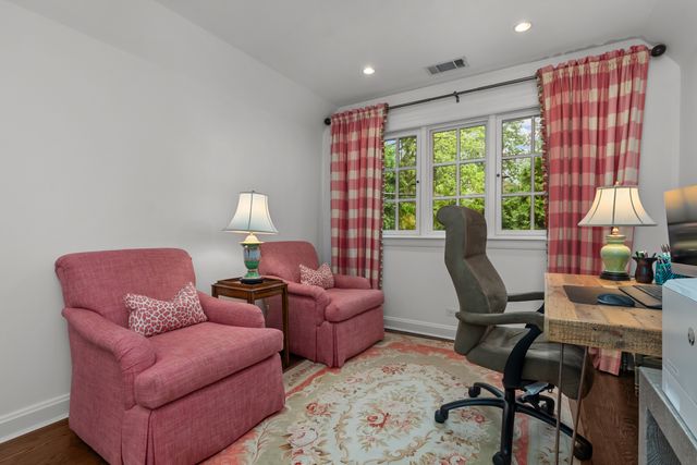 a bedroom with a bed and large windows