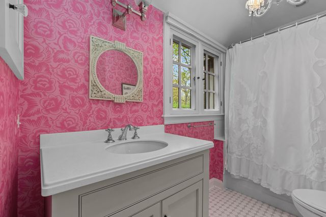 a bedroom with a bed chair and a window