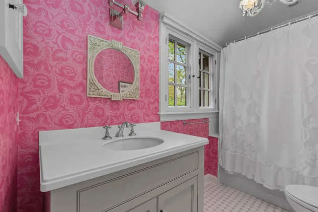 a bedroom with a bed chair and a window