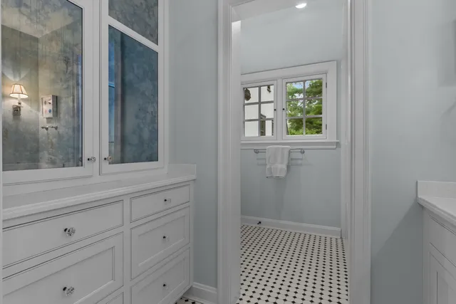 a bathroom with a sink a mirror and a window