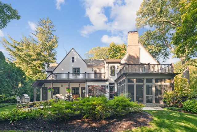 a front view of a house with a yard and fountain