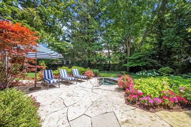 a view of a backyard with table and chairs and potted plants