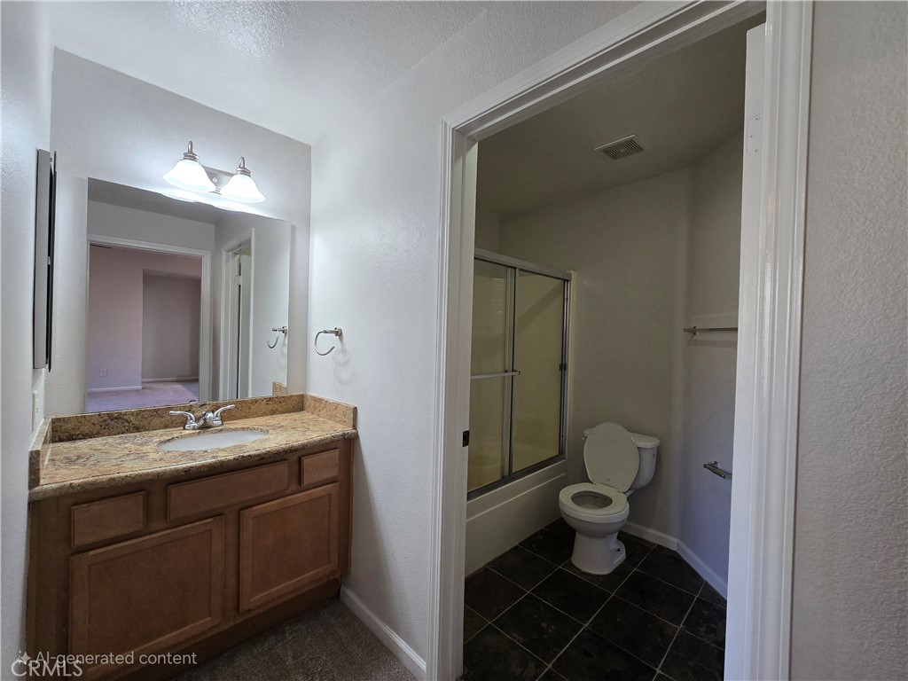 375 Central Avenue, Unit 14 Riverside, CA 92507 - Photo 18 of 22 a bathroom with a granite countertop sink toilet and shower