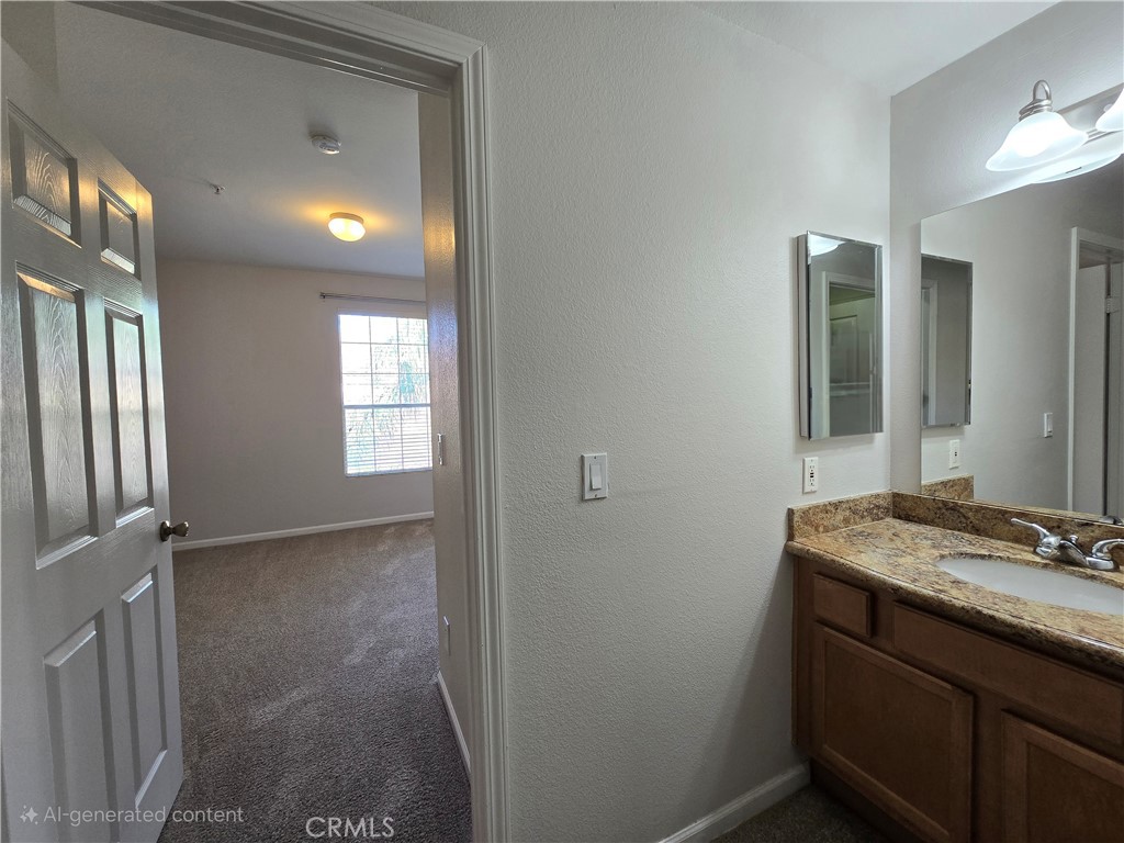 375 Central Avenue, Unit 14 Riverside, CA 92507 - Photo 19 of 22 a bathroom with a granite countertop sink a toilet and mirror