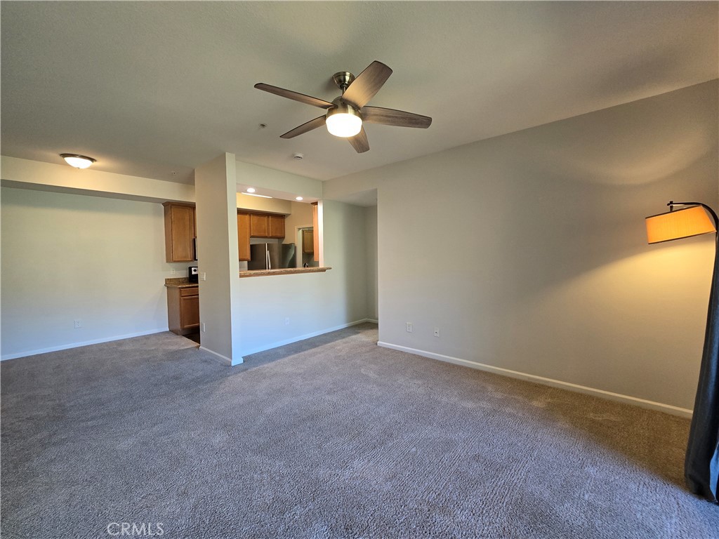 375 Central Avenue, Unit 14 Riverside, CA 92507 - Photo 7 of 22 an empty room with chandelier fan and windows