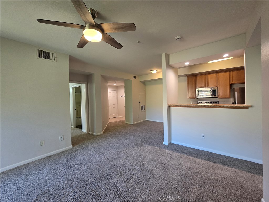 375 Central Avenue, Unit 14 Riverside, CA 92507 - Photo 8 of 22 a view of a kitchen with a sink and a refrigerator