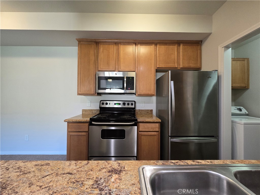 375 Central Avenue, Unit 14 Riverside, CA 92507 - Photo 10 of 22 a kitchen with a refrigerator sink and stove