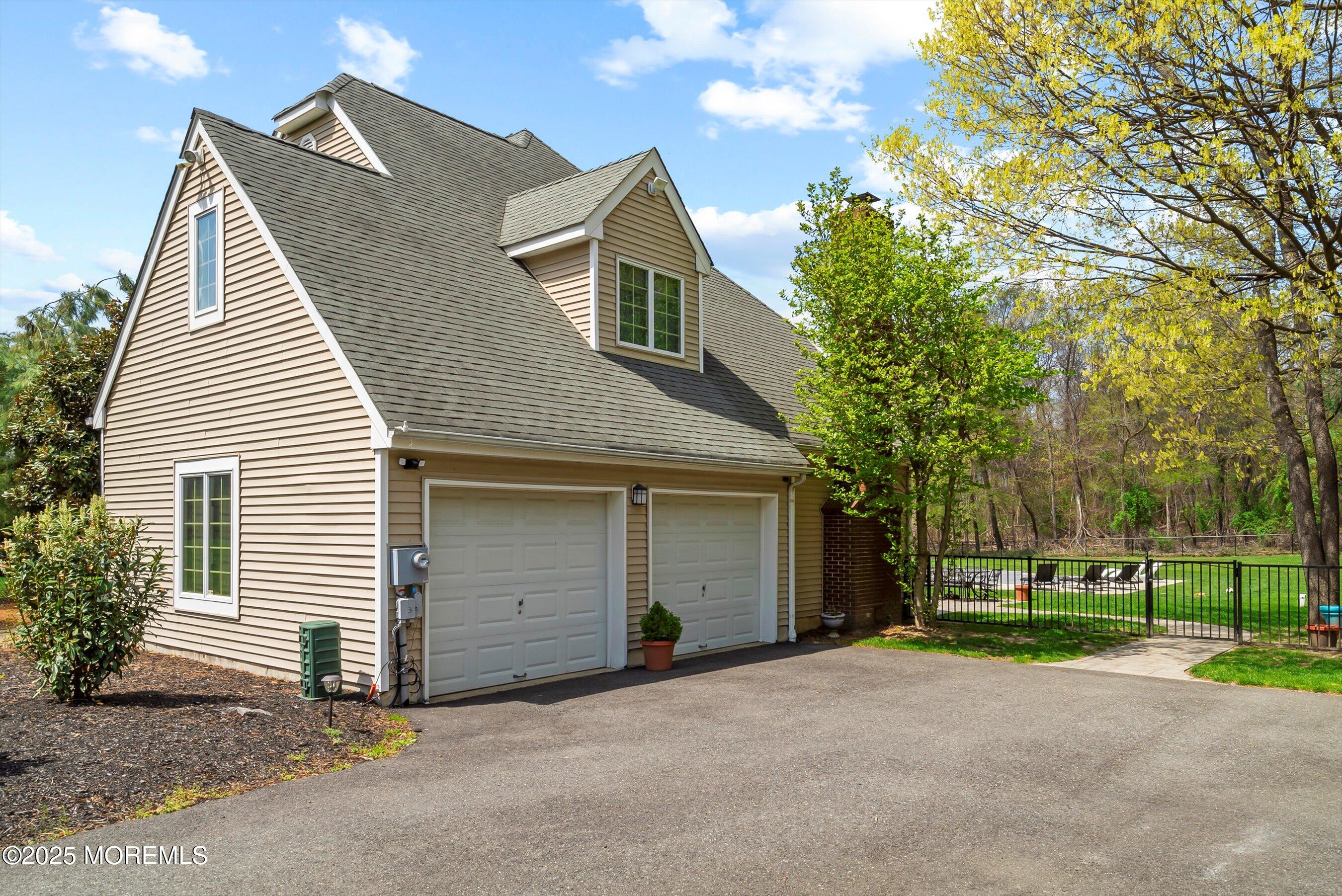 39 Primrose Lane Colts Neck, NJ 07722 - Photo 15 of 52 a view of a house with a yard and garage