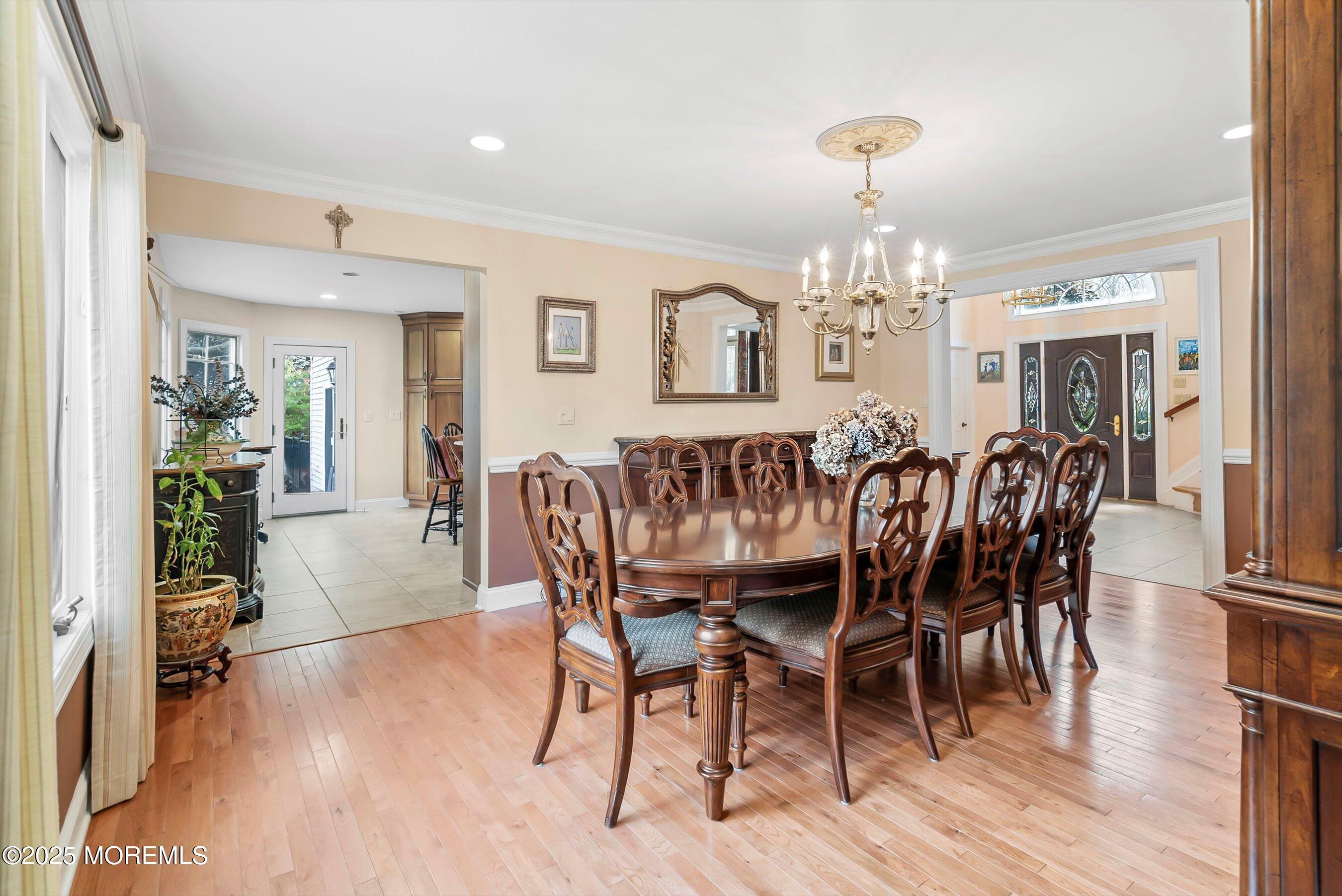 39 Primrose Lane Colts Neck, NJ 07722 - Photo 19 of 52 a dining room with furniture a chandelier and wooden floor