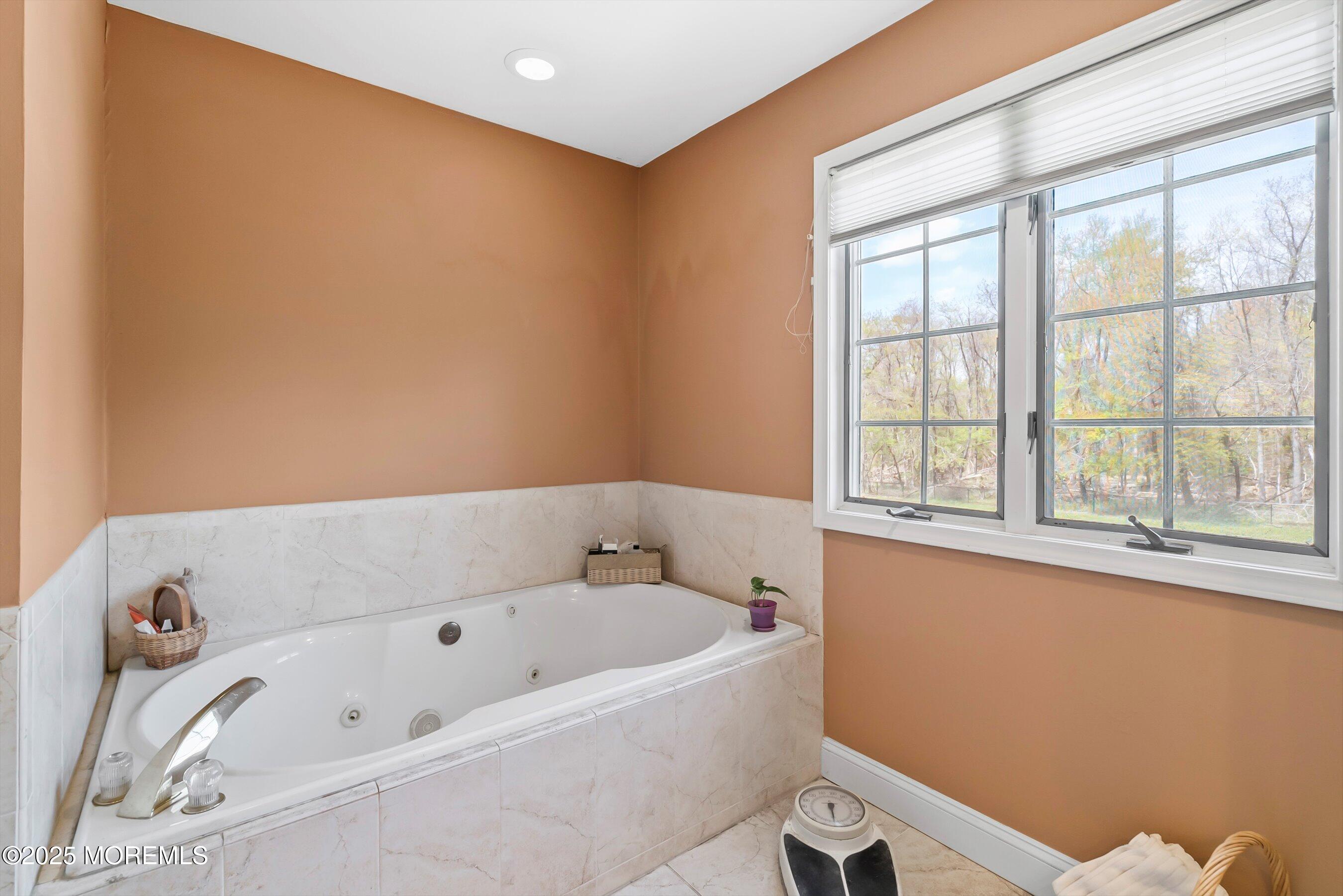 39 Primrose Lane Colts Neck, NJ 07722 - Photo 46 of 52 a bathroom with a bathtub and next to a window