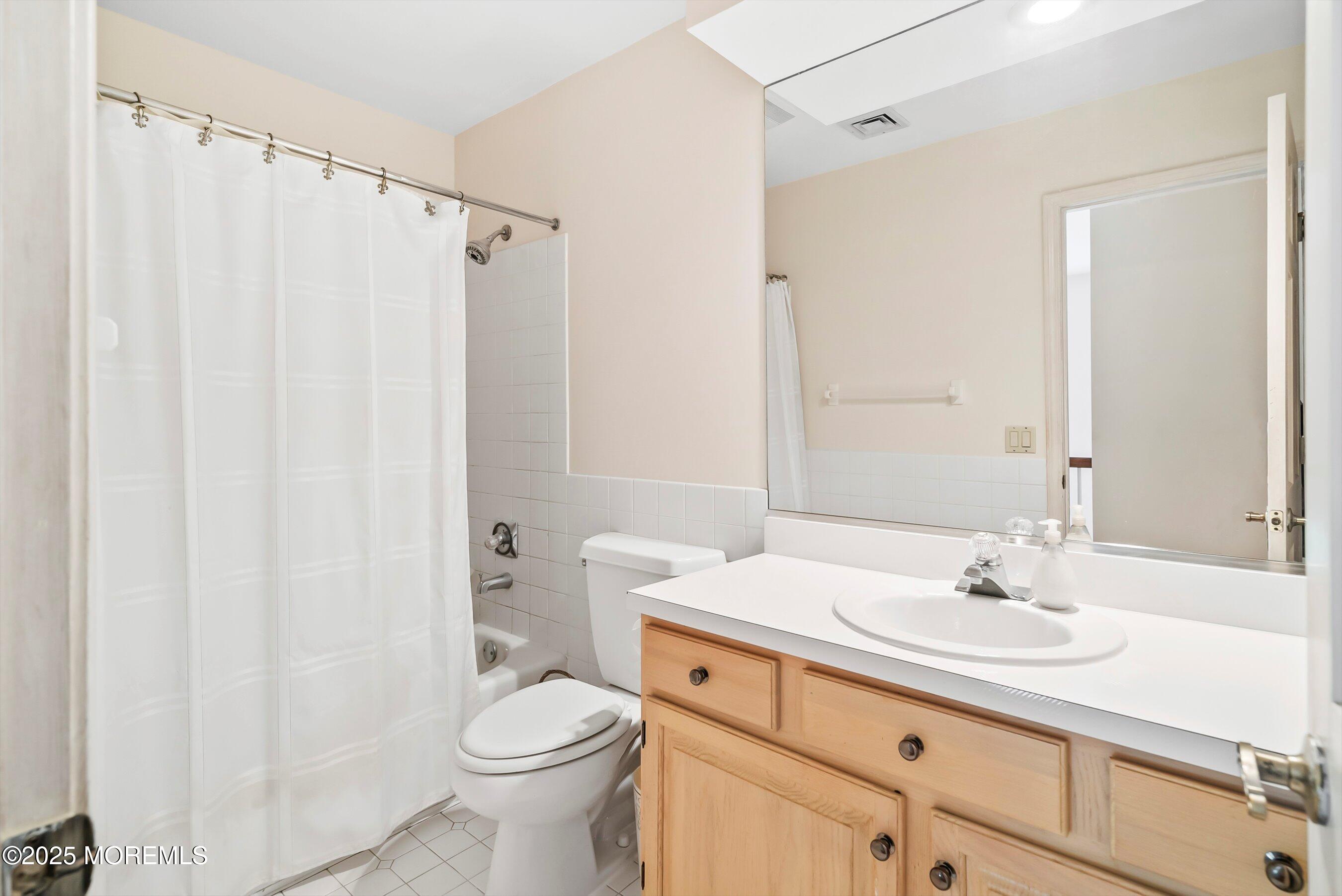 39 Primrose Lane Colts Neck, NJ 07722 - Photo 48 of 52 a bathroom with a sink a toilet and shower curtain